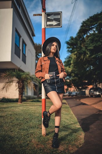 Woman Leaning on Pole