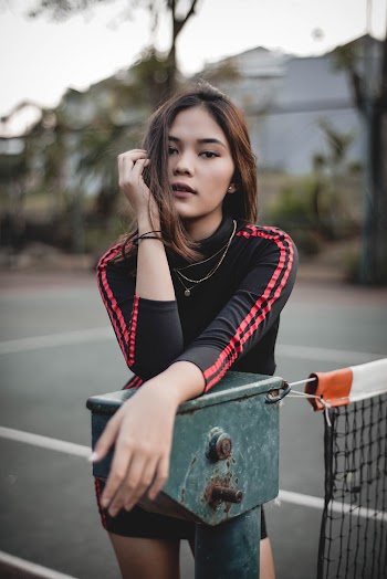 Woman Leaning on Post