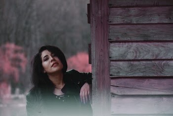 Woman Leaning on Purple Wood