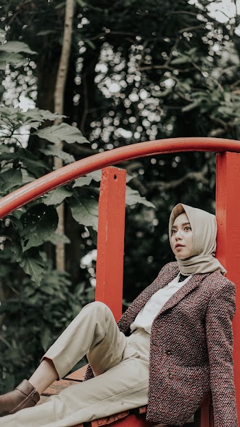 Woman Leaning On Red Railing