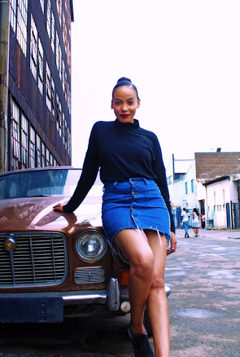 Woman Leaning on Red Vehicle Wearing Black Turtleneck Long-sleeved Shirt