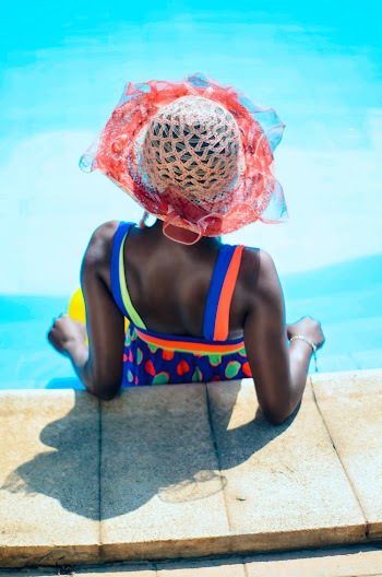 Woman Leaning on Side of the Pool