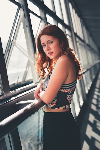 Woman Leaning on Stainless Steel Railin