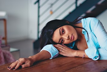 Woman Leaning on Table