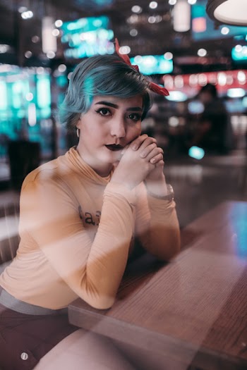 Woman Leaning on Table