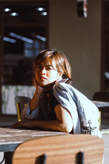 Woman Leaning on Table