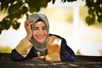 Woman Leaning on Table and Smiling