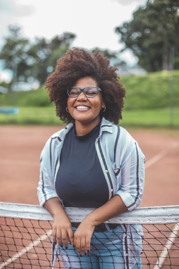Woman Leaning on Tennis Net