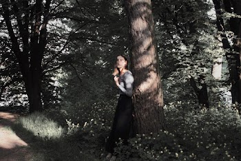Woman Leaning on the Bark of a Tree
