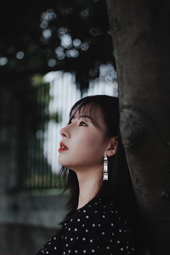 Woman Leaning on Tree