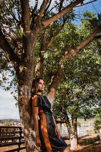 Woman Leaning on Tree