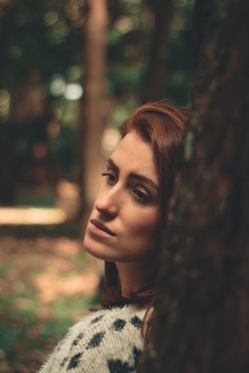 Woman Leaning on Tree