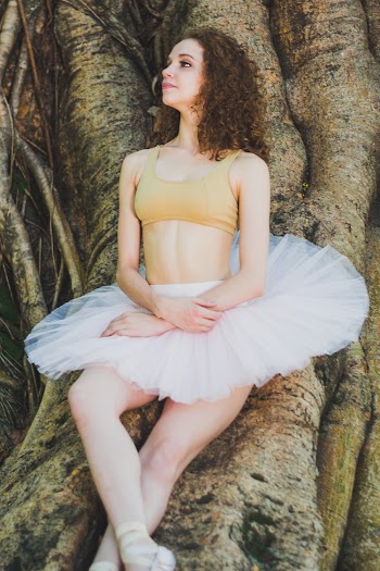 Woman Leaning on Tree Bark