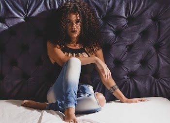 Woman Leaning on Tufted Wall