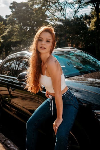 Woman Leaning on Vehicle