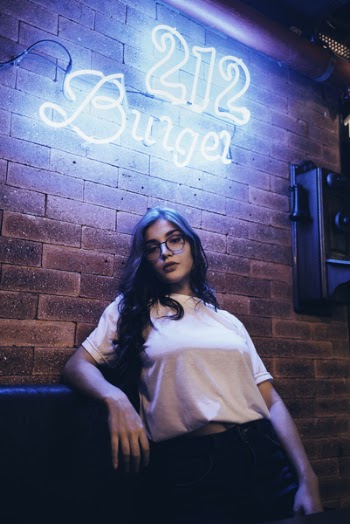 Woman Leaning on Wall