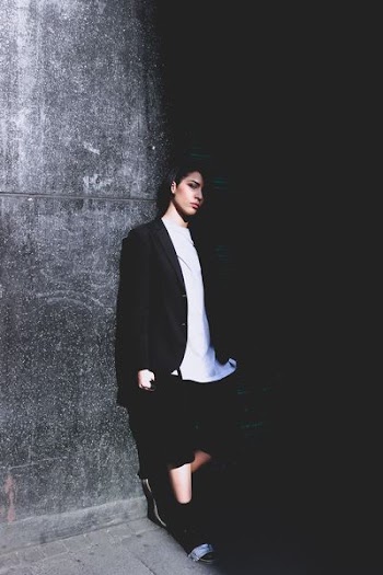 woman leaning on wall