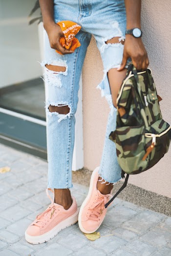 Woman Leaning on Wall Carry Camouflage Backpack