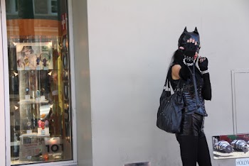 Woman Leaning on Wall Wearing Black Cat Costume