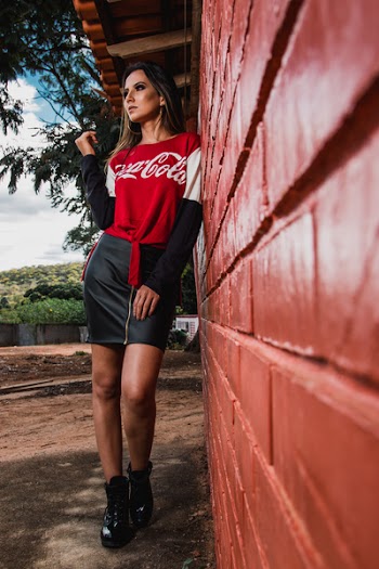 Woman Leaning On Wall Wearing Coca-cola Printed Top