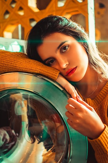 Woman Leaning On Washing Machine