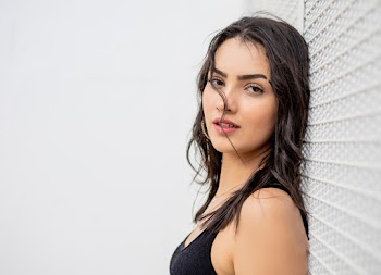 Woman Leaning On White Fence