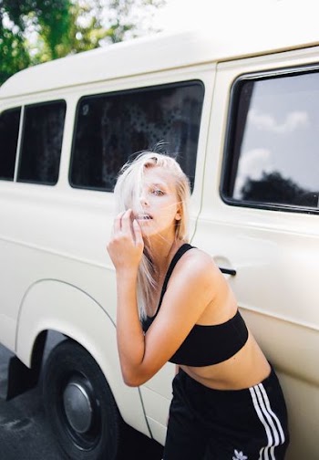 woman leaning on white van