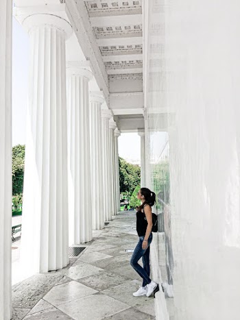 Woman Leaning on White Wall