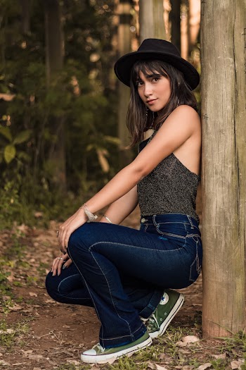 Woman Leaning on Wooden Pole