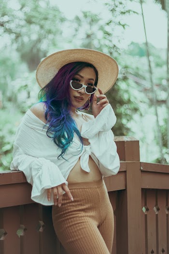 Woman Leaning on Wooden Railing