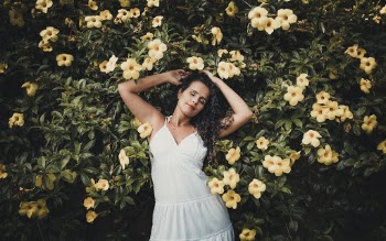 Woman Leaning on Yellow Bell Flower