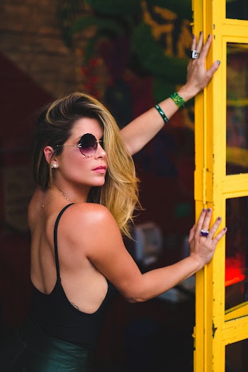 Woman Leaning on Yellow Ladder