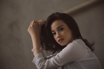 Woman Left Hand on Hair Wearing White Long-sleeved Shirt