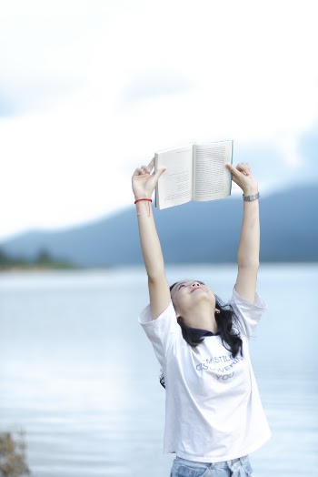 Woman Lifting Opened Book