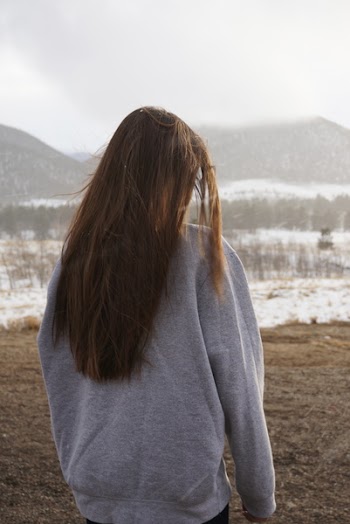 Woman Looking at a Cliff