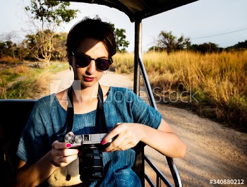 Woman Looking at Camera and Cheking Photos
