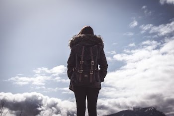 woman looking at clouds under blue sky during daytime
