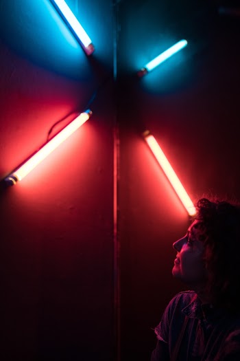 Woman Looking at Florescent Lamps