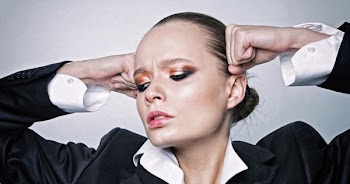 Woman Looking Downward Holding Her Head