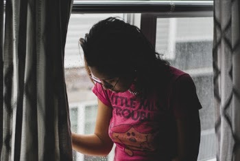 Woman Looking Out The Window