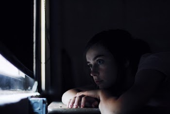 Woman Looking Out The Window