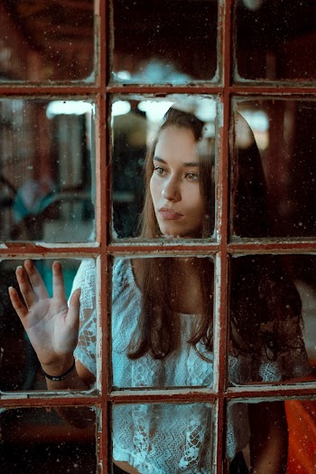 Woman Looking Through the Glass Window