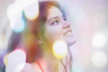 Woman Looking Up Surrounded With Lights