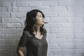 Woman Looking Up While Wearing Headphones