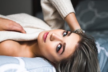 Woman Lying At The Edge Of Bed