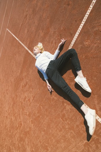 Woman Lying Down on a Brown Concrete Surface