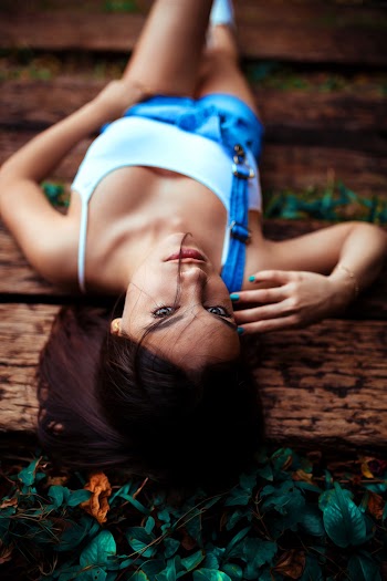 Woman Lying Down on Wooden Pad