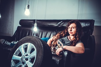 Woman Lying in Black Leather Couch