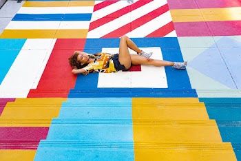 Woman Lying On A Colorful Floor