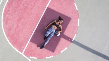 Woman Lying on Basketball Court